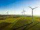 Aerial View of Wind Turbines and Agriculture Field in the Early Morning at Sunrise.