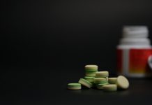 close-up young women holding pills vitamin