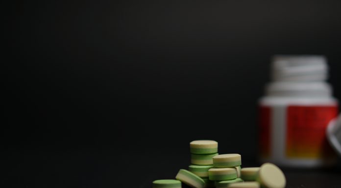 close-up young women holding pills vitamin