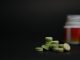 close-up young women holding pills vitamin