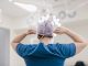 Female surgeon tying surgical mask in operation theater at hospital