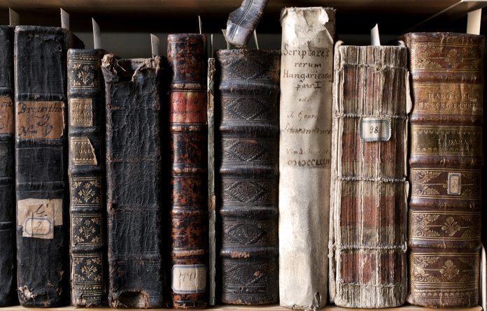 "400 year old antique books in a library. Photo was taken at avaible light, for accurate representation of the atmosphere inside."