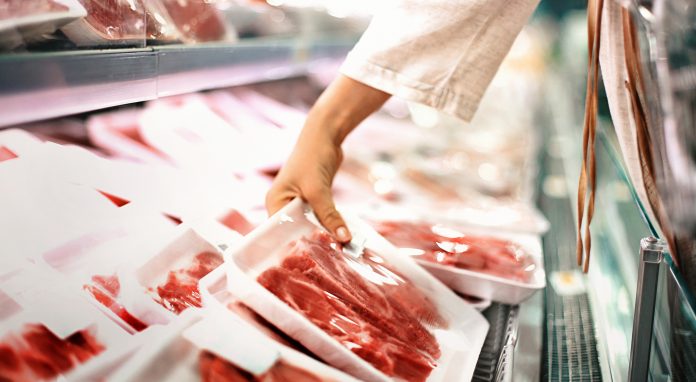 Buying meat at a supermarket.