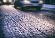 Cars on a snowy road at night