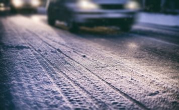 Cars on a snowy road at night