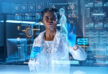 A young African - American doctor works on HUD or graphic display in front of her