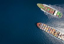 High aerial top down view of two container cargo ships traveling over open ocean with copy space as a concept for import and export industry