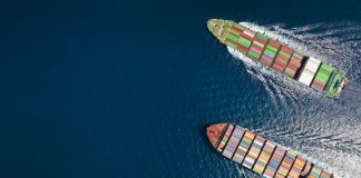 High aerial top down view of two container cargo ships traveling over open ocean with copy space as a concept for import and export industry