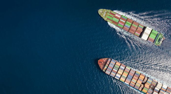 High aerial top down view of two container cargo ships traveling over open ocean with copy space as a concept for import and export industry