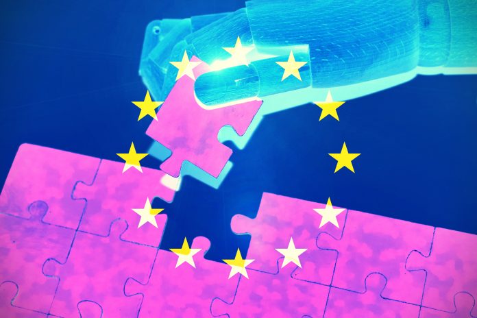 Robot hand solving a jigsaw puzzle with the European flag as background .