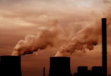 Coal power plant with chimney and cooling towers, air pollution