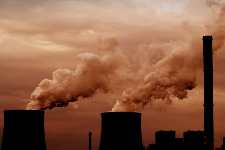 Coal power plant with chimney and cooling towers, air pollution