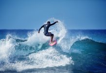 Male surfer surfing on waves