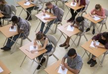 Elevated view of students writing their GCSE exam