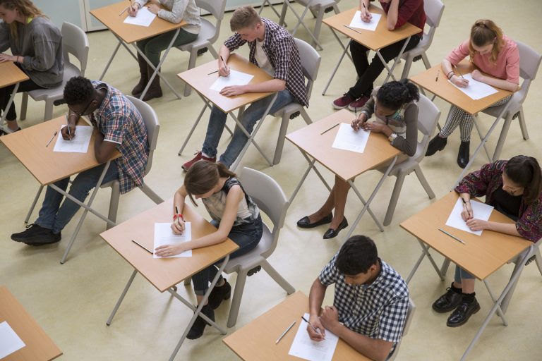 Elevated view of students writing their GCSE exam