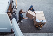 Coworkers rushing to load packages in a delivery van