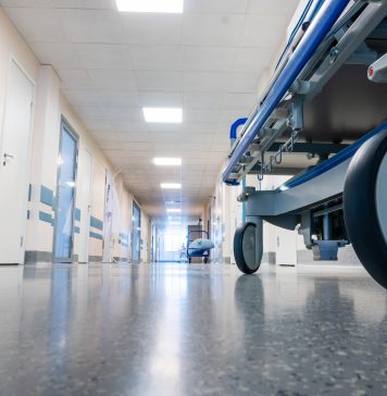 Medical bed on wheels in the hospital corridor.