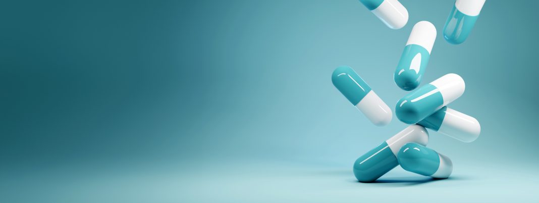 A group of antibiotic pill capsules fallling. Healthcare and medical 3D illustration background.