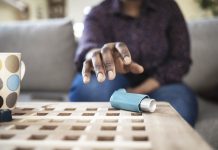 man reaching for asthma pump