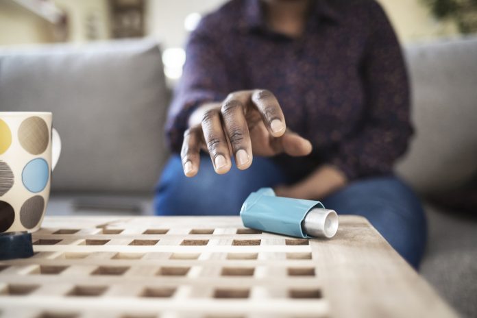 man reaching for asthma pump