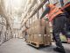 Motion blur of two men moving boxes in a warehouse