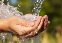 Woman's hands with water splash