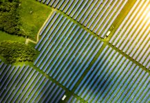 Aerial view over Solar cells energy farm in countryside landscape