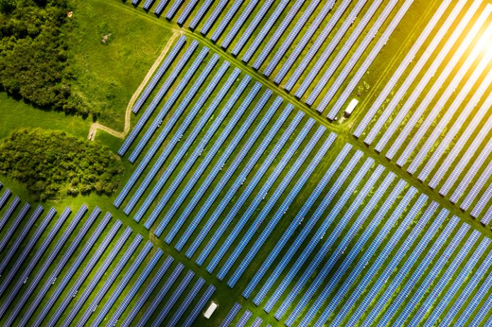 Aerial view over Solar cells energy farm in countryside landscape