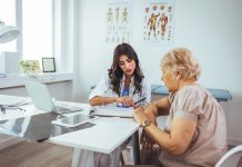 Female doctor consult mature client in clinic or hospital.