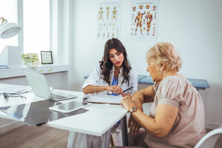 Female doctor consult mature client in clinic or hospital.