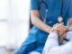 Cropped shot of a female nurse hold her senior patient's hand. Giving Support. Doctor helping old patient with Alzheimer's disease. Female carer holding hands of senior man