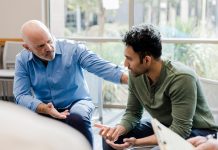 Mature man helps younger man verbalize problems in therapy