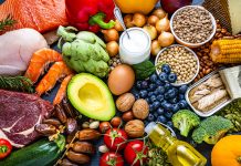 Overhead view of a large group of healthy raw food for flexitarian mediterranean diet. The composition includes salmon, chicken breast, canned tuna, cow steak, fruits, vegetables, nuts, seeds, dairi products, olive oil, eggs and legumes. High resolution 42Mp studio digital capture taken with SONY A7rII and Zeiss Batis 40mm F2.0 CF lens