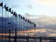 International flags on industrial background at sunset. Global warming and united nations concept.