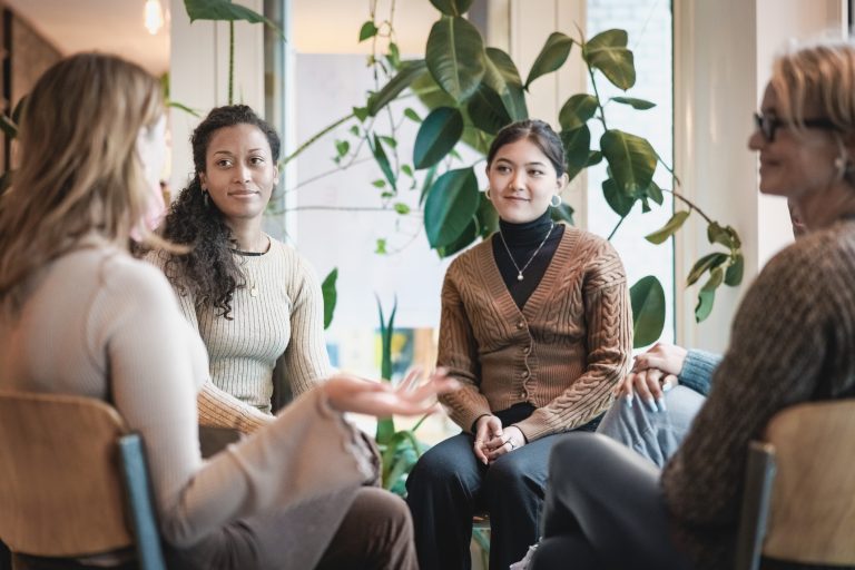 Woman sharing her experiences during a group therapy session