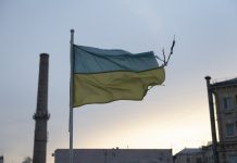 A weathered Ukrainian flag flies in the Podil district of Kyiv, Ukraine