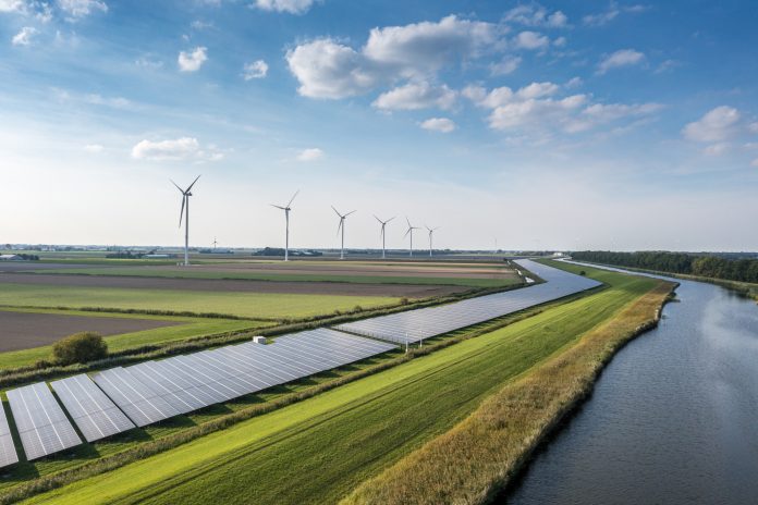 Solar panels and wind turbines generating renewable energy for green and sustainable future.