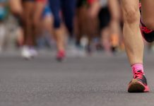 Marathon runners running on city road, large group of runners