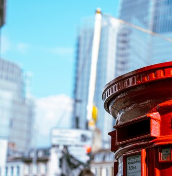 Postbox in London beneath skyscrapers