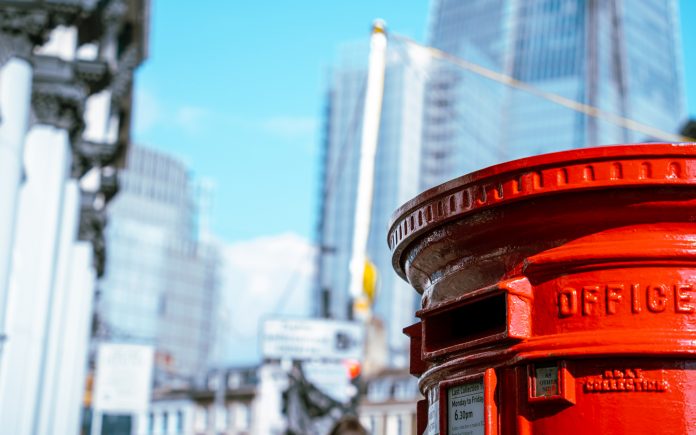 Postbox in London beneath skyscrapers