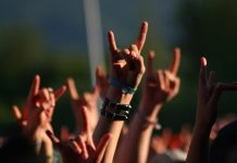 Hands in air at concert making rock sign gesture