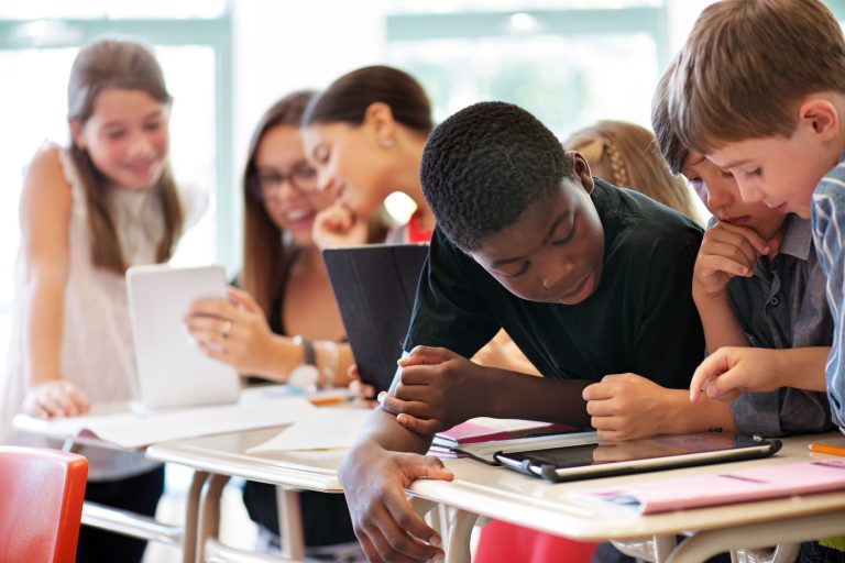 School kids in class using a digital tablet