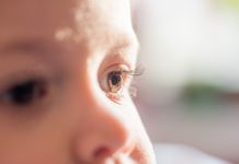 baby dark brown eyes close-up. Side look