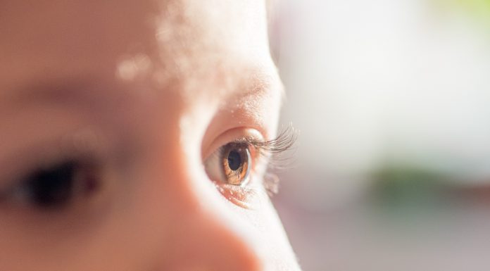 baby dark brown eyes close-up. Side look