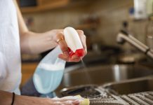 Cleaning kitchen table with cloth