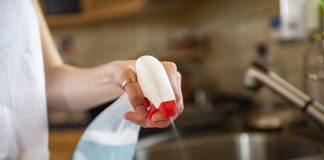 Cleaning kitchen table with cloth