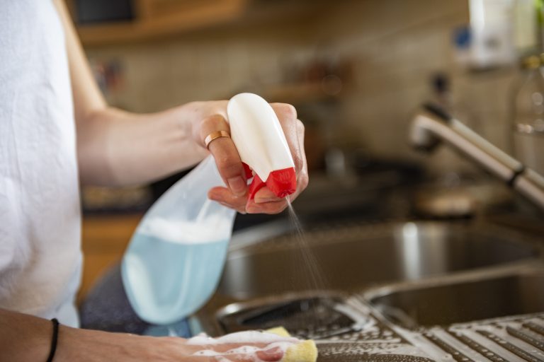 Cleaning kitchen table with cloth