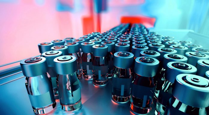 Close-up of medicine glass vials on a pharmaceutical production line, with metal caps and blank labels, moving forward. Industrial background, manufacturing equipment. Teal and orange hues. Digitally generated image. Selective focus.