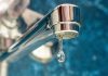 A drop of water drips from a leaky faucet