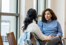 Supervisor meets with mid adult female employee to mentor her regarding a new position she is interested in